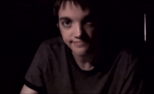 a close up of a person 's face in the dark .