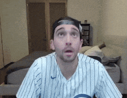 a man in a striped shirt and hat is looking up