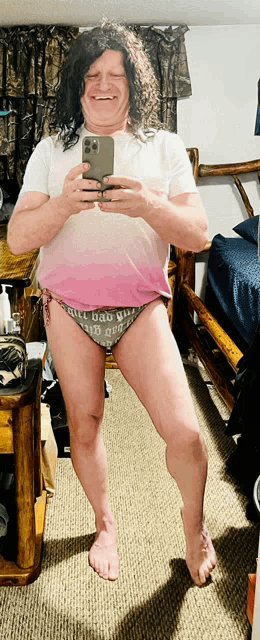 a man is taking a picture of himself in a pink bikini