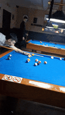 a pool table with a no smoking sign