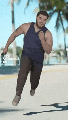 a man with a beard is jumping in the air while wearing slippers .