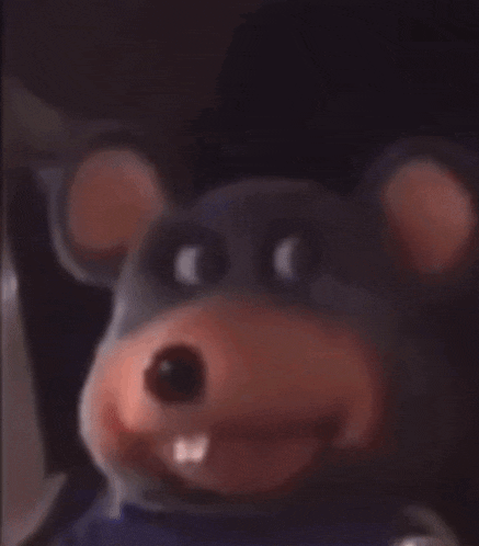 a close up of a stuffed animal that looks like a mouse with teeth