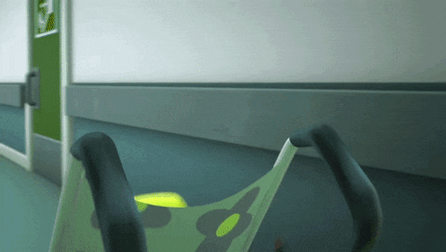 a green exit sign hangs on the wall of a hallway