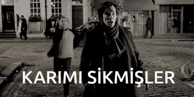 a black and white photo of a man walking down a street with the words karimi sikmisler above him