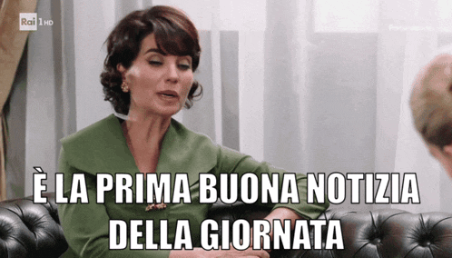 a woman sitting on a couch with the words " e la prima buona notizia della giornata " on the bottom