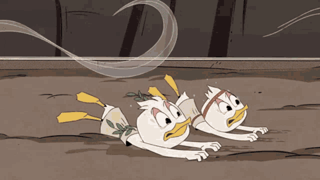 two cartoon ducks are laying on the ground and one has a red headband on