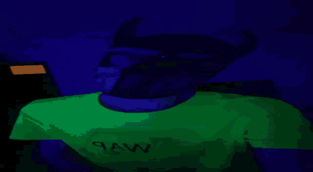 a man is wearing a green shirt that glows in the dark and has the word daw on it