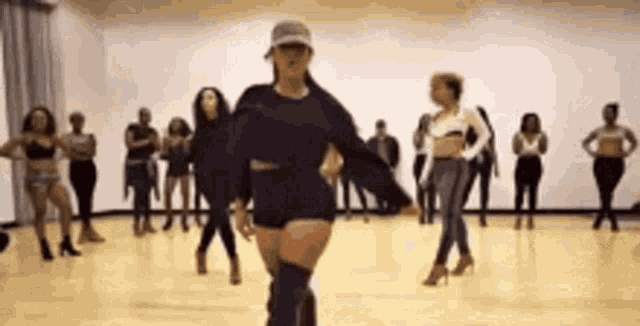 a group of women are dancing together in a room .