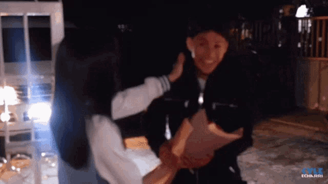 a blurry photo of a man and a woman with the words style tobari in the upper left corner