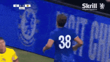 a soccer player wearing a blue jersey with the number 38 on the back