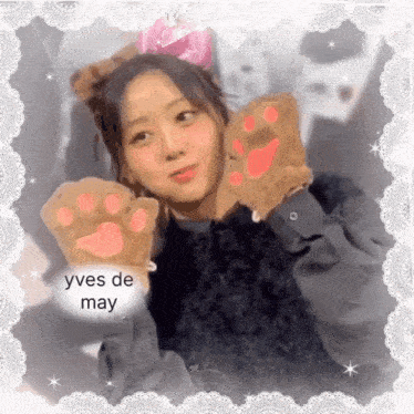 a picture of a girl wearing cat paw gloves with the name yves de may written on the bottom