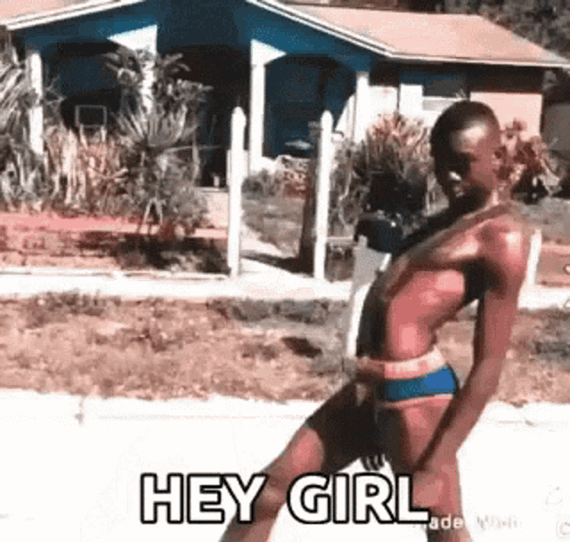 a man in a bikini is walking down the street and saying hey girl .