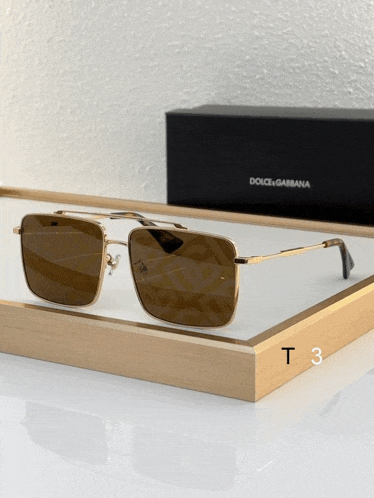 a pair of dolce & gabbana sunglasses sits on a white tray