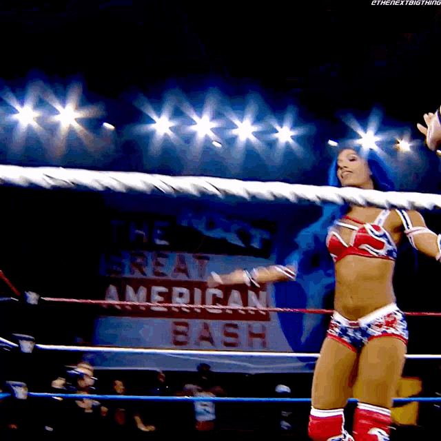 a woman in a wrestling ring with a sign that says the great american bash on it