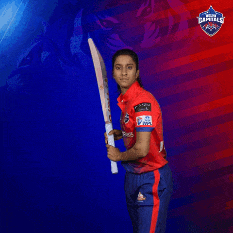 a female cricket player is swinging a bat with a hero logo on it