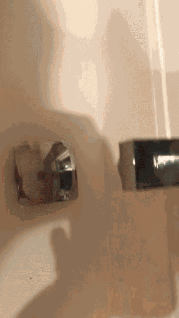 a close up of a faucet on a bathroom wall