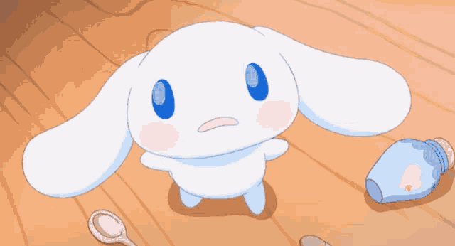a white rabbit with blue eyes is standing on a wooden floor next to a bottle