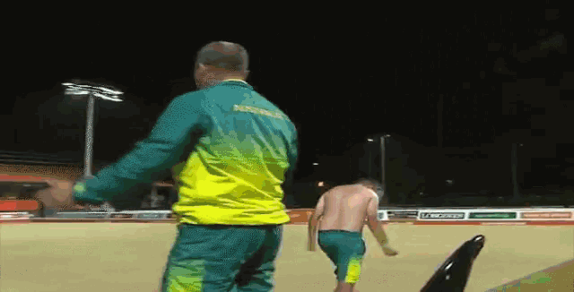 a man in a yellow and green jacket with the word australia on the back