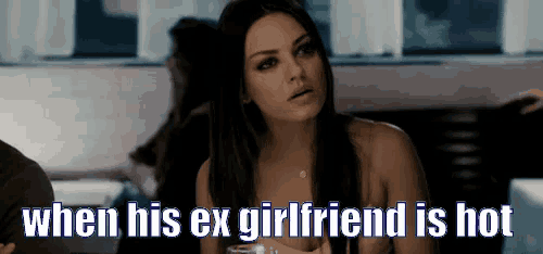 a woman is sitting at a table with a glass of wine and the words when his ex girlfriend is hot