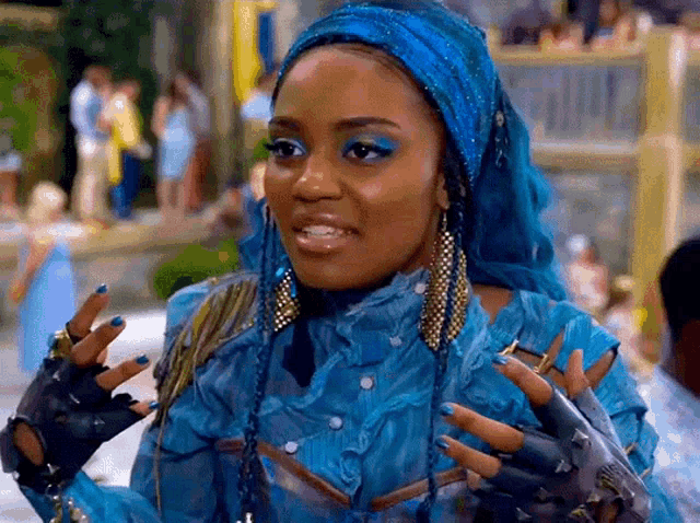 a woman with blue hair is wearing a blue outfit and gloves