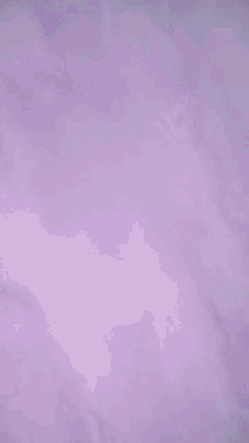 a cartoon character is standing in a purple room with a purple background .