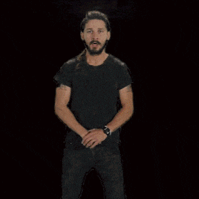 a man in a black shirt stands in front of a fire with the words do it written in white