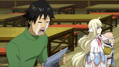 a man in a green sweater is crying while holding a tablet in front of a group of tables