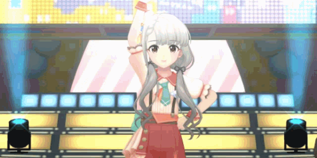 a girl in a red dress is standing on a stage in front of a microphone .
