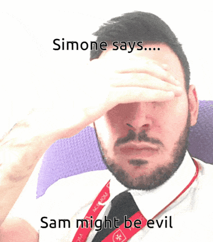 a man with a beard is sitting in a chair and says simone says ... sam might be evil