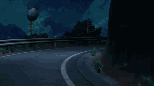 a yellow car is driving down a curvy road