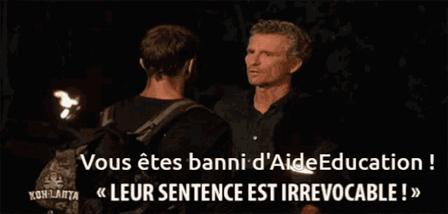 two men standing next to each other with kohlanta in the corner