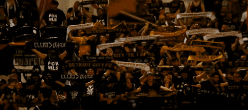 a crowd of people wearing scarves that say detroit city