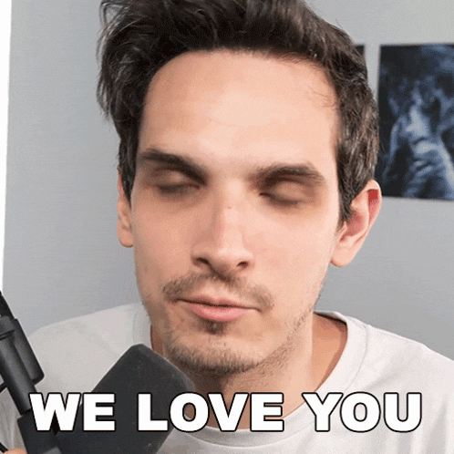 a man with his eyes closed is holding a microphone and says " we love you "
