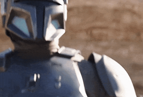 a close up of a robot wearing a helmet and armor