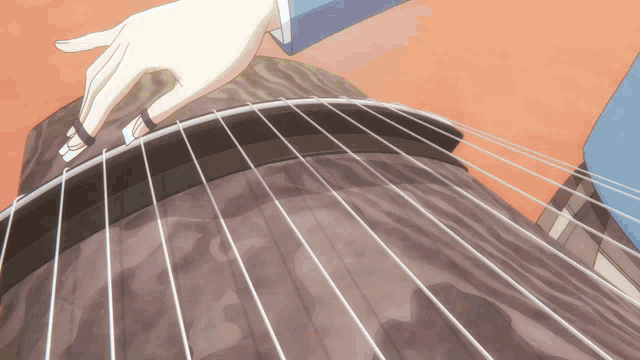 a close up of a person playing a guitar