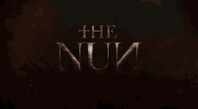 a dark background with the words " the nun " written on it