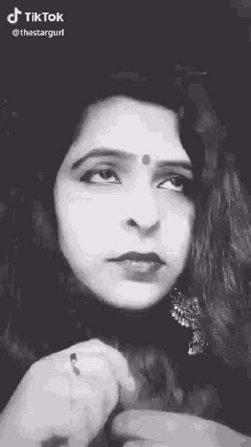 a black and white photo of a woman 's face .