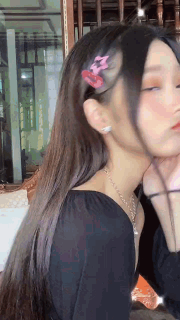 a close up of a woman 's face with a hair clip on her head .