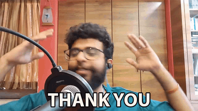 a man with a beard and glasses says thank you