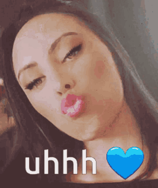 a woman with a blue heart and the words uhhh on her face