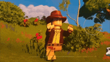 a lego man in a cowboy hat standing in a field