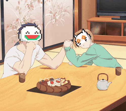a man and a woman are sitting at a table with a cake on it