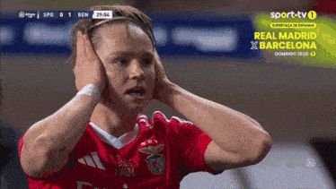 a soccer player is covering his ears during a game sponsored by sporttv