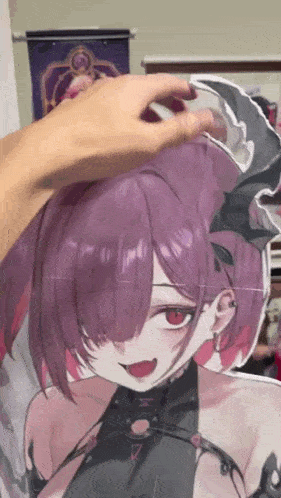 a person is touching a picture of a girl with purple hair .