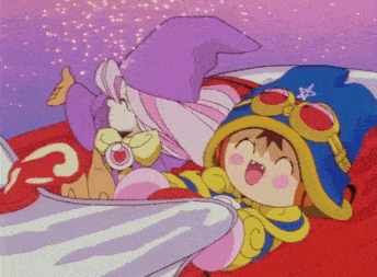 a girl in a purple hat and a boy in a blue hat are laying on a bed