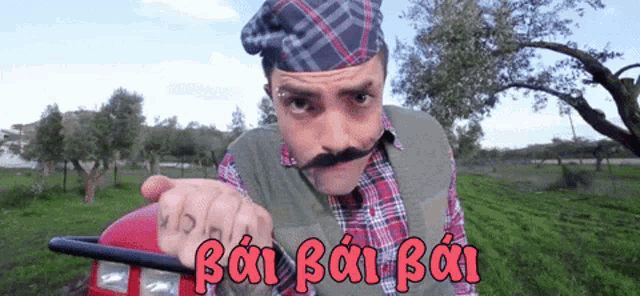 a man with a mustache is driving a tractor with the words bai bai bai written on the side