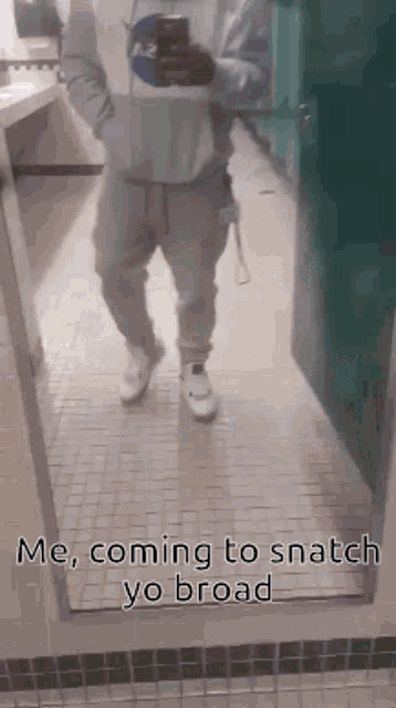 a man is taking a picture of himself in a mirror in a bathroom .