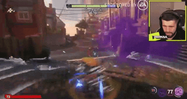 a man playing a video game with a sponsored by ea logo on the screen