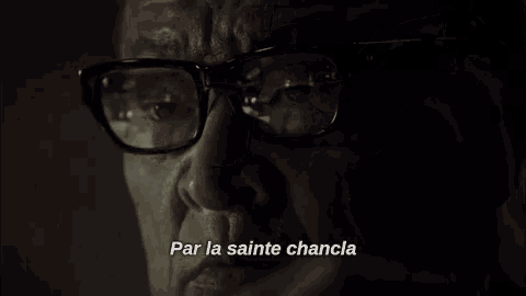a close up of a man 's face with the words par la sainte chancla written below him