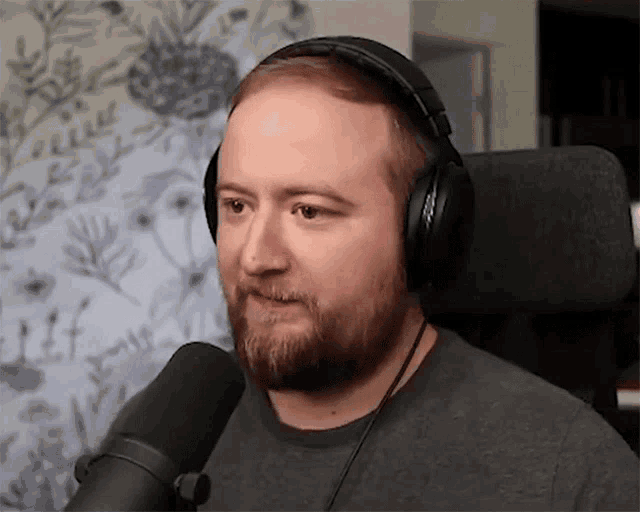 a man with a beard wearing headphones and a microphone